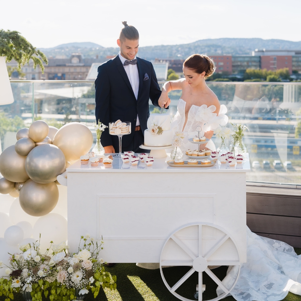 SweetCarts Budapest elegáns desszertkocsijai különféle rendezvényeken: stílusos SweetCart desszertkocsi pasztell színű dekorációval és édességekkel, tematikus dekoráció lufikkal és kiegészítőkkel babaváró, születésnapi vagy esküvői eseményeken, óriás labdamedence gyerekek számára biztonságos és vidám környezetben, valamint céges promóciós kocsik logóval és arculati elemekkel marketing eseményeken vagy rendezvényeken Budapesten.